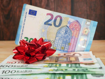 Money Gift, Money and bow on wooden background, closeupの写真素材