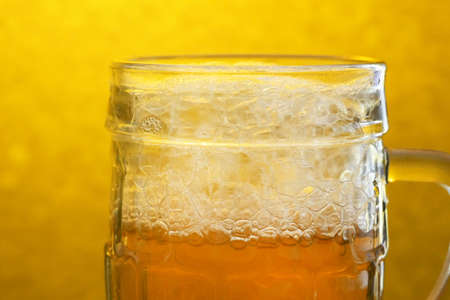 Beer Glass On A Wooden Table. Craft Beer festival. Beer with foam in a pub. Alcohol drink, closeupの写真素材