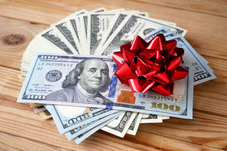 Money Gift, Money and bow on wooden background, closeupの写真素材