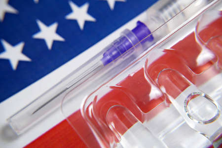 american flag, syringes with vaccine and money, money for purchase and production vaccine, closeupの写真素材