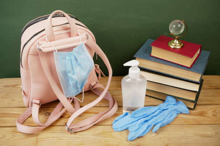 Back To School, book pile, sanitizer and medical mask, closeupの写真素材