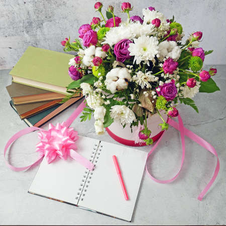 stack of books and a bouquet of flowers on artistic background. Teacher's Day. Still lifeの写真素材