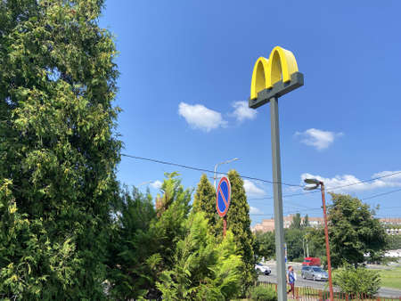 McDonald's logo sign. McDonald's is the world's largest chain of hamburger fast food restaurants,...