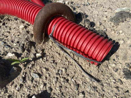 plastic water pipe lies on the ground, closeup