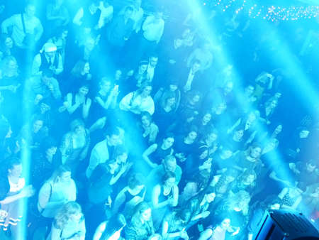 Crowd of people at party waving arms in the air, people dancing in night club, top viewの写真素材