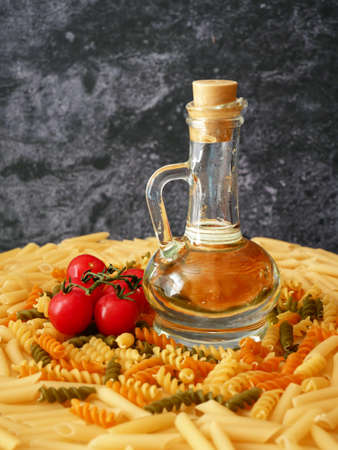 Various types of pasta, Raw pasta set and tomato, set, closeupの写真素材