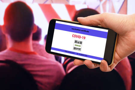 Vaccination passport on a mobile phone allowing on offline meetings Vaccination against the coronavirus Covid 19. Community or Health passport, closeupの写真素材