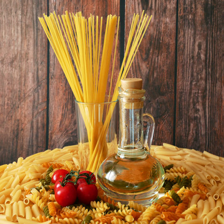 Various types of pasta, Raw pasta set and tomato, set, closeupの写真素材