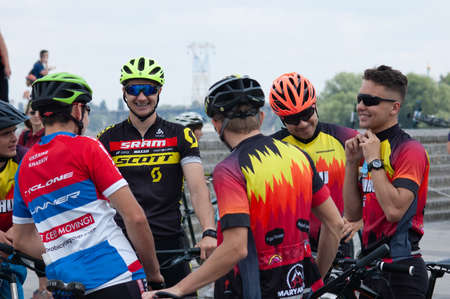 Cyclist in helmet on during cycle ride in city in summer day, closeupのeditorial素材