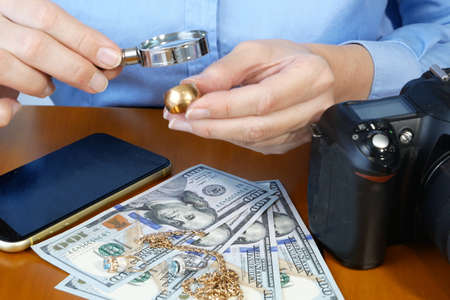 Pawn shop worker verify jewelery and photo or video camera and give money. Customers Buy and Sell...