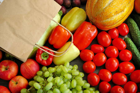 many different fruit and vegetables and papaer bag, green glocery shop, healthy fresh colored fruits and vegetables background delivery concept. Zero wasteの写真素材