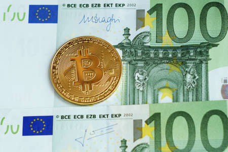 Bitcoin new virtual money and banknotes of euro. Exchange bitcoin for a dollar. Concept. Closeup