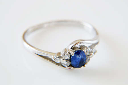 ring with blue sapphire and white diamonds around, jewerly shop, pawnshop concept, closeupの写真素材