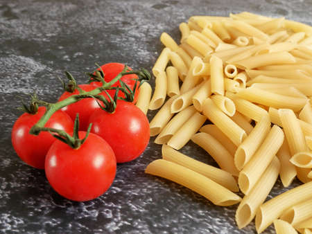 Various types of pasta, Raw pasta set and tomato, set, closeupの写真素材
