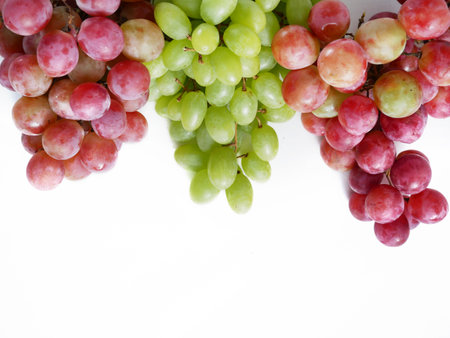 Tasty juice green and red Grapes branch isolated on white background, closeupの写真素材