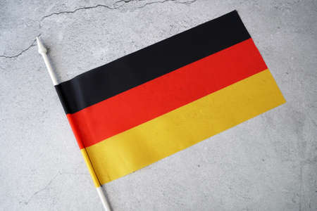 Germany flag on gray background. Day of German Unity - 3 october. Closeup