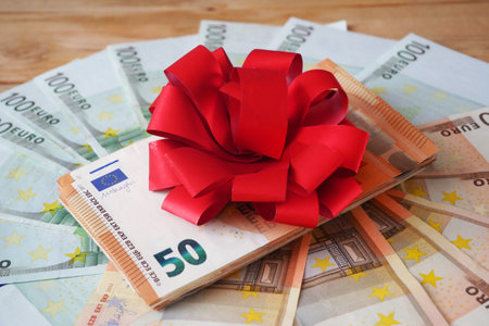 Money Gift, Money and bow on wooden background, closeupの写真素材