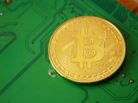 golden bitcoin and motherboard, block chain concept, closeup