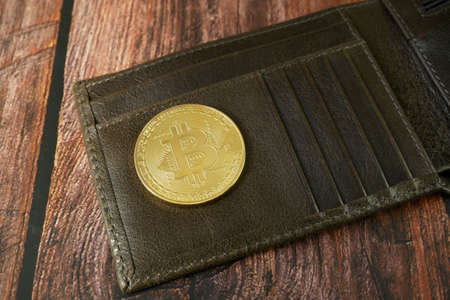 golden bitcoin and wallet, block chain concept, closeup