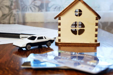 House model with real estate contract to buy house, insurance or loan and credit bank card real estate background, closeupの写真素材