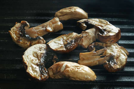 mushrooms grilled in a cast iron grilling pan, view from above, closeup