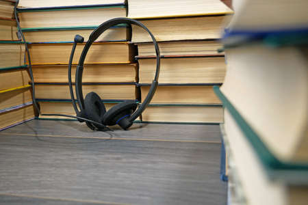 Headphones and books on wooden background, Audio book concept. online library archive. close upの写真素材