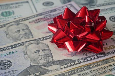 stack of euro cash money and red bow background, money gift concept, closeup