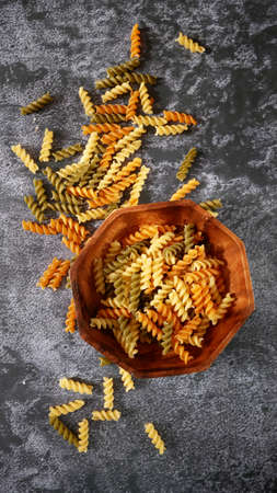 uncooked Various types of pasta, Raw pasta set and tomato, set, top view, closeup