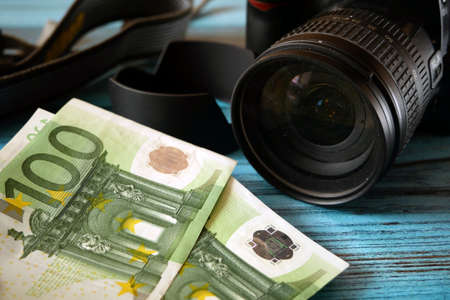 digital photo and video camera and money, store selling photographic equipment, pawnshop, closeupの写真素材