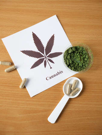 CBD Hemp pills and extracts. Cannabis drugs, marijuana buds and dry grass. Cannabis pills containers with CBD. alternative medicine. top viewの写真素材