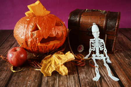 Funny happy halloween skeleton and pumpkin Jack O Lantern. Halloween festive for banner, poster, greeting card, party invitation on blacks, closeupの写真素材