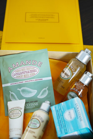 Lviv, Ukraine - 02 11 2023; L'Occitane French provence cosmetics in yellow box - face and body cream, eye's cream, shampoo, oil, body milk, scrub, top view, closeupのeditorial素材