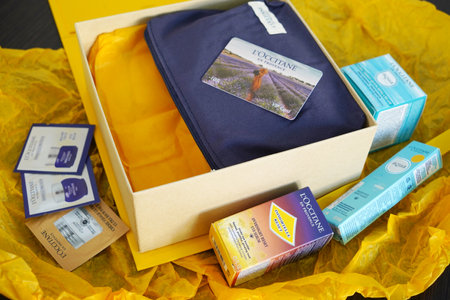 Lviv, Ukraine - 02 11 2023; L'Occitane French provence cosmetics in yellow box - face and body cream, eye's cream, shampoo, oil, body milk, scrub, top view, closeupのeditorial素材