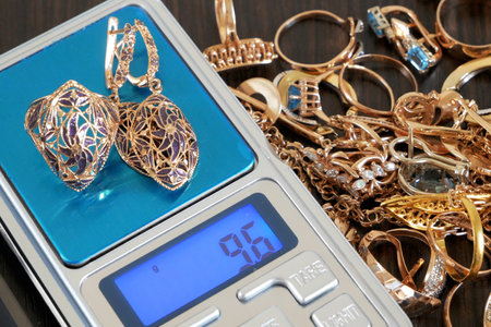 Pawnshop concept, composition with jewelry scales and a lot of gold jewelry, top view, flat layの写真素材