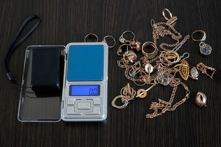 Pawnshop concept, composition with jewelry scales and a lot of gold jewelry, top view, flat layの写真素材