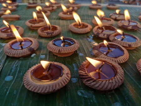 Festival of candles paraded on banana leavesの写真素材