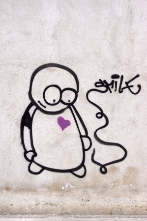 Graffiti of sad man on the wall. Don't worry, be happy.の写真素材