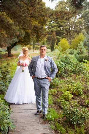 Newlyweds on a walk in the summer day weddingの写真素材