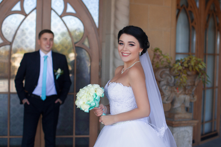 Stylish newlyweds posing against the retro doorの写真素材