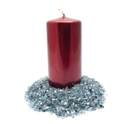 Red candle on blue glitterの写真素材