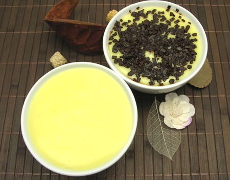 Custards with and without grated chocolate in bowls of china wareの写真素材