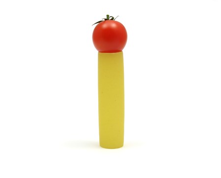 One unboiled canneloni with one red tomato の写真素材