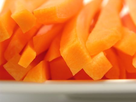 Julienne carrots on a white plate and white backgroundの写真素材