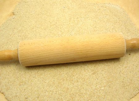 Rolled out  wholemeal dough with a rolling pinの写真素材