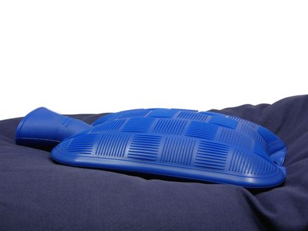 Blue hot-water bag on a blue pillowの写真素材