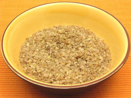 A close-up view on bulgur wheat groats in a bowl of ceramicの写真素材