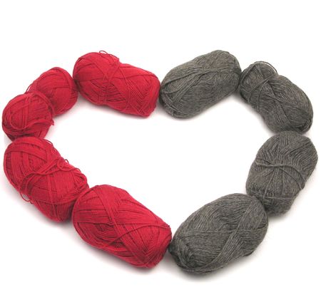 Gray and red new wool as heart on white backgroundの写真素材