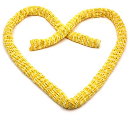 Yellow striped knitting scarf arranged as heart on whiteの写真素材