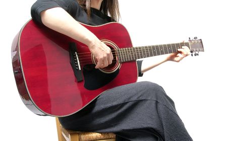 Cutout woman with guitar sitting on a chairの写真素材