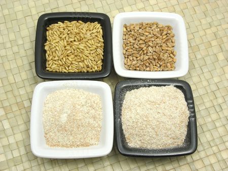 Bowls of chinaware with cereal and wholemeal on rattan matの写真素材